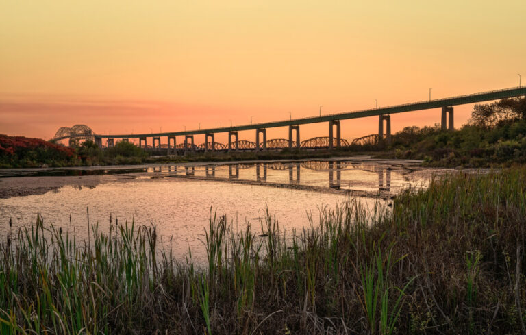 A bridge over water at sundown.