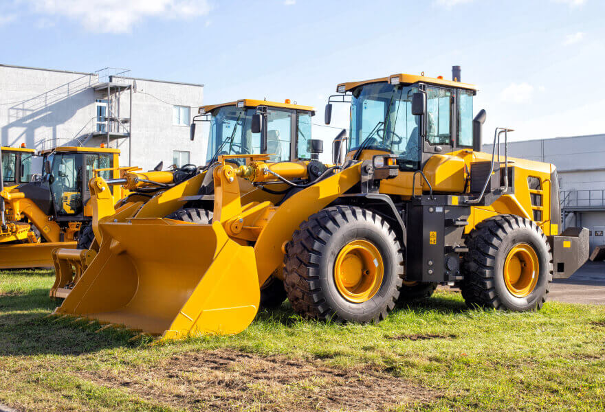 Bulldozers lined up at a construction site