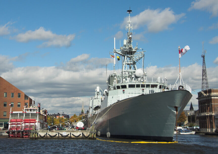 Military frigate docked at port