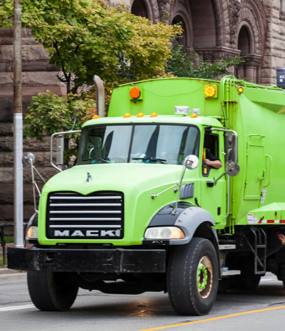 The front of a green truck carrying hazardous waste.