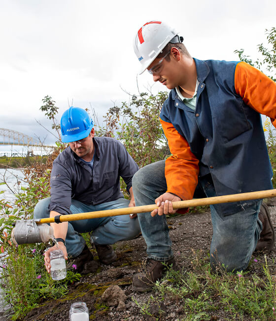 Two Algoma employees monitoring the quality of water.